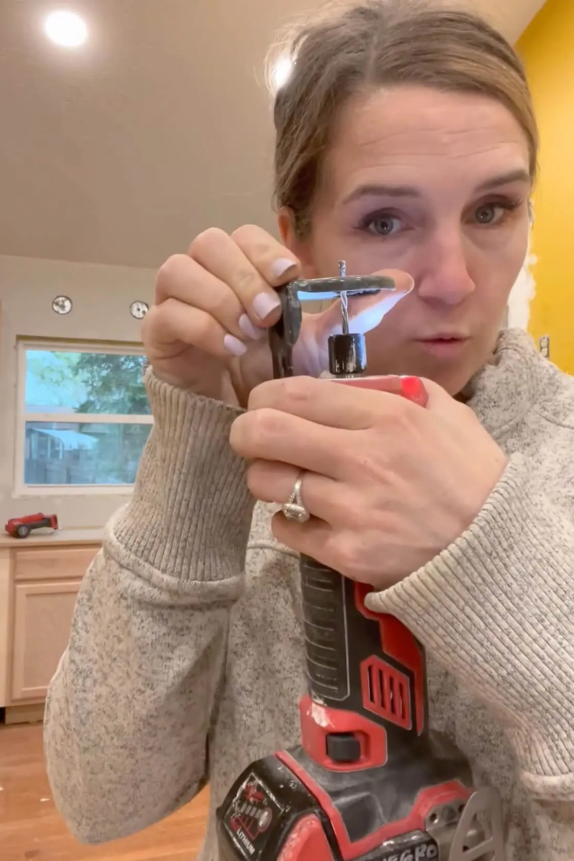 Demonstrating a drywall cut out tool.